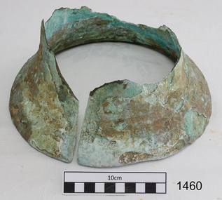 Lower section of a brass bell, split