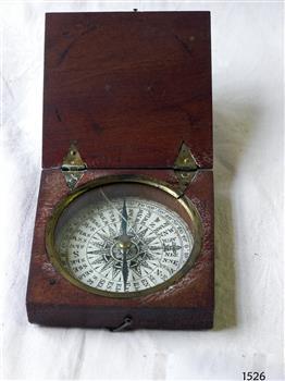 Wooden box with a hinged lid containing a magnetic compass
