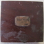 Rectangular brass plaque attached to compass with inscription