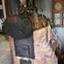 Front of boiler has a red plaque. The boiler is mounted above a brick structure