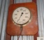 Gauge mounted on timber. Dial is white with black markings around it and a pointer attached in the centre