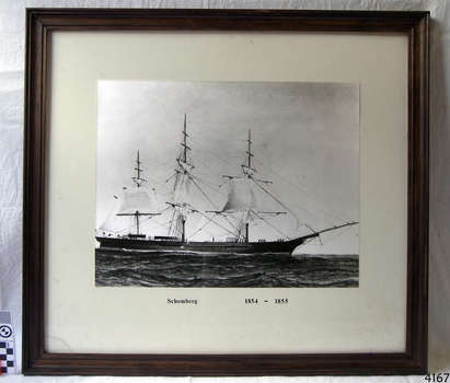 Photograph, black and white, of sailing vessel. Title under photograph.