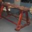 The long steering gear is supported by a wooden stand with metal brading