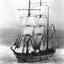 Black and white photograph of a three masted ship at sea