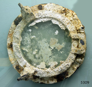 Porthole with class, covered with encrustations