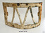 Metal frame is headily encrusted. Fixing bolt's heads are visible. Metal rods form 'V' shape.