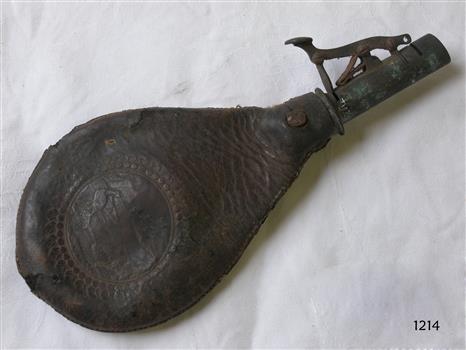 Bulbous decorative tooled leather pouch with metal mechanical fitting attached to the narrow mouth