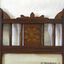Wooden panel has inlaid motif of  a circle inside a square inside a star, all different tomber