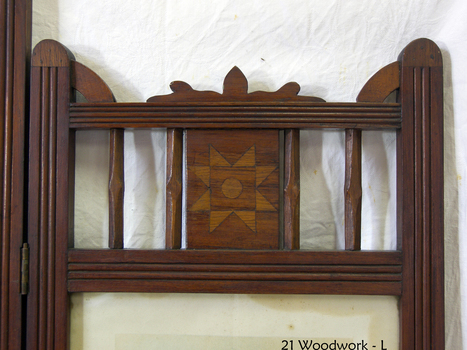 Wooden panel has inlaid motif of  a circle inside a square inside a star, all different tomber