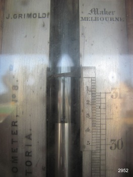 The maker's name and location are printed on the metal surrounding the barometer, made in Melbourne