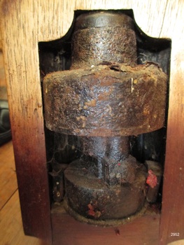 Base is a heavy metal chamber encased by a timber frame.