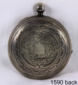 Front of the watch case, etched in a decorative pattern