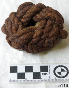Sample of rope has been crafted into a 'monkey fist' or 'Turk's head' knot, which is a ball shape.
