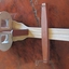 The wood and metal slide holder has a channel on the metal holder along which it can move