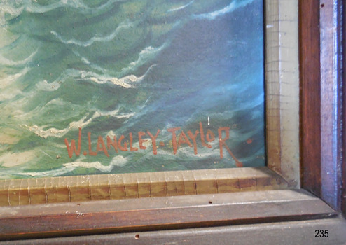 Painted using red-brown paint, in capital letters “W. LANGLEY-TAYLOR.”