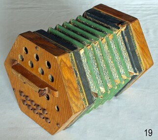 Concertina has wooden ends joined with a folded paper expanding and contracting arrangement.