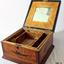 Underside of lid has a mirror. Base has a removable partitioned insert. 