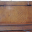 The back is plain, showing metal hinges for the lid. 