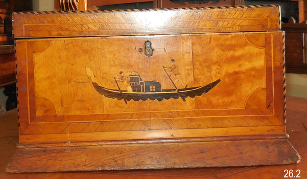 Inlaid image depicts figures on a gondola. 