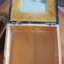 The lid is lined with pieces of light coloured wood.