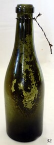 Green glass bottle, upright, with pushed up base