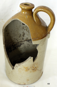 Ceramic jug with small handle and narrow mouth, dark brown top, cream base