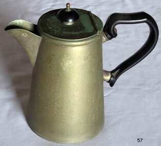 Tall metal jug with black handle and flip-up lid. Sides of jug flare down outwardly.