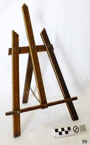 Wooden music stand has three legs, a vertical support and two horizontal supports. The back leg adjusts via a chain.