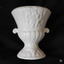 White ceramic vase on short pedestal with two tiny side handles and moulded pattern