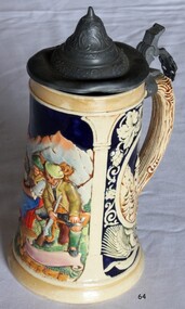 Ceramic beer stein with decorative design and flip top lid