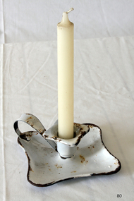 White enameled metal candlestick holder, square with rounded corners, loop handle.
