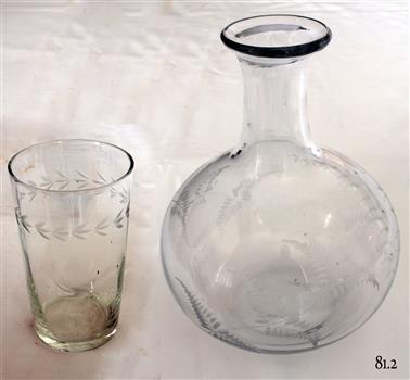 Clear water tumbler and carafe with decorative etching in the glass