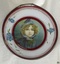 Metal frame with wide white and crimson border, glass front, print behind glass, card back