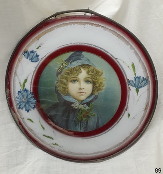 Metal frame with wide white and crimson border, glass front, print behind glass, card back