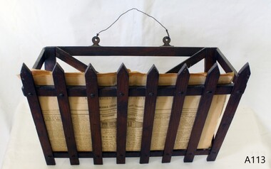 Brown wooden basket with sides resembling a picket fence