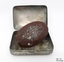 Metal soap tin with oval cake of brown fragrant soap