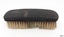 Brush has brown shaped handle grip and yellow bristles.