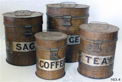 Four metal canisters in a group