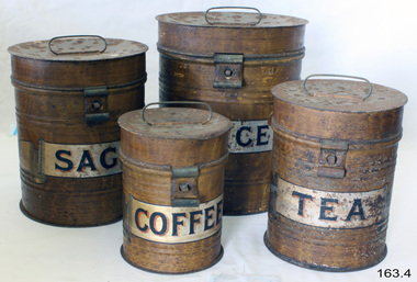 Four metal canisters in a group