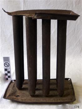 upright metal cylinders with open tops and closed base, mounted on top and bottom plates