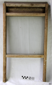Rectangular ribbed glass pane within a wooden frame with two legs.