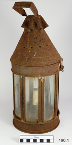 Lamp has metal framed windows around the sides, and a conical tope with a metal handle