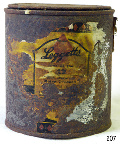 Tin has straight sides and a lid. Remnants of the paper label remain.