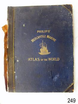 Large book, blue cover, black spine and corners, embossed gold letters, image of gold ship on water
