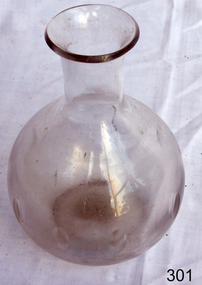 Clear glass carafe with narrow neck and bulbous base