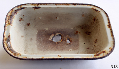 White oblong enamel baking dish with the remains of a blue enamel line around rim.