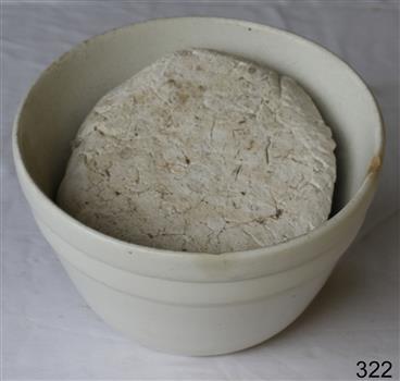White ceramic earthenware bowl. Bad chip on edge.