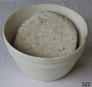 White ceramic earthenware bowl. Bad chip on edge.