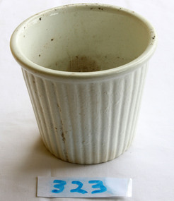  White ceramic ribbed pudding mould, partly discoloured.