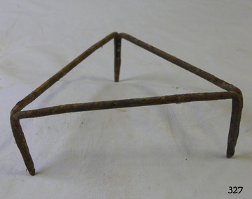 Triangular frame of metal tube with three legs.